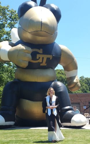 Heather Johnston poses with a giant inflatable Buzz on her graduation day.